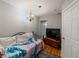 Snug bedroom boasting a vibrant patterned bedspread, rich hardwood floors, and soft lighting at 1223 Union St, Clearwater, FL 33755