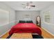 Cozy bedroom features light gray walls, a ceiling fan, wood floors, and natural light from the window at 1223 Union St, Clearwater, FL 33755