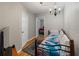 Cozy bedroom featuring a colorful bedspread, hardwood floors, and a classic chandelier at 1223 Union St, Clearwater, FL 33755