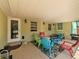 Spacious covered patio with colorful seating options and outdoor access, perfect for gatherings at 1223 Union St, Clearwater, FL 33755