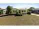Lovely yellow home featuring a bright blue door and shutters, enhanced curb appeal at 1223 Union St, Clearwater, FL 33755