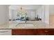Open-concept kitchen with granite countertops offering a view into the bright living room at 1223 Union St, Clearwater, FL 33755