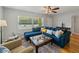Bright living room featuring a large window, comfortable blue sofa, and natural lighting at 1223 Union St, Clearwater, FL 33755