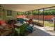Enclosed patio with seating for outdoor relaxation and entertaining in a private backyard at 1223 Union St, Clearwater, FL 33755