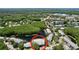 Aerial view of condos and community area surrounded by trees and a lake at 1337 Pine Ridge E Cir # D2, Tarpon Springs, FL 34688