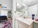 A clean bathroom with a white vanity and a view into the main bedroom at 1337 Pine Ridge E Cir # D2, Tarpon Springs, FL 34688