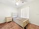 Neutral bedroom with a platform bed, side table, and natural light from the window at 1337 Pine Ridge E Cir # D2, Tarpon Springs, FL 34688