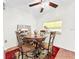 Comfortable dining area with decorative lighting fixture and kitchen view at 1337 Pine Ridge E Cir # D2, Tarpon Springs, FL 34688