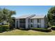 Well maintained condo building with mature trees and landscaping at 1337 Pine Ridge E Cir # D2, Tarpon Springs, FL 34688