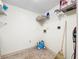 A bright laundry room with overhead shelving at 1337 Pine Ridge E Cir # D2, Tarpon Springs, FL 34688