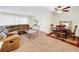 Spacious living room featuring fan, sofa, and adjacent dining area at 1337 Pine Ridge E Cir # D2, Tarpon Springs, FL 34688