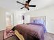 Comfortable main bedroom with a ceiling fan and an ensuite bathroom at 1337 Pine Ridge E Cir # D2, Tarpon Springs, FL 34688