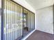 Cozy patio featuring sliding glass doors and textured flooring at 1337 Pine Ridge E Cir # D2, Tarpon Springs, FL 34688