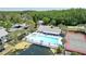 Community pool and hot tub surrounded by lush greenery near a lake at 1337 Pine Ridge E Cir # D2, Tarpon Springs, FL 34688