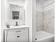 Bright bathroom features modern vanity with marble-look shower surround at 1339 13Th W St, Bradenton, FL 34205