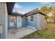 Back view of the home, showing a side entrance and patio area at 1339 13Th W St, Bradenton, FL 34205