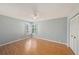 Bright bedroom with wood floors, plantation shutters, and a ceiling fan at 13625 Dunwoody Ct, Hudson, FL 34667