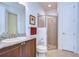 Bathroom featuring granite countertop vanity, sink, toilet, and walk-in shower with glass door at 16318 Palmettoglen Ct, Lithia, FL 33547
