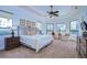 Inviting bedroom with abundant natural light, tray ceiling, and comfortable furnishings at 16318 Palmettoglen Ct, Lithia, FL 33547