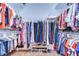 Walk-in closet with shelving and racks for ample storage space with clothing and shoes at 16318 Palmettoglen Ct, Lithia, FL 33547