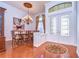 Elegant dining room boasting hardwood floors, decorative chandelier and double doors at 16318 Palmettoglen Ct, Lithia, FL 33547