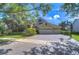 Charming home featuring a three car garage, manicured lawn and a brick paved driveway at 16318 Palmettoglen Ct, Lithia, FL 33547