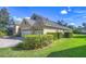 Lovely home showcases a three-car garage, a lush green lawn, and neatly trimmed hedges enhancing its appeal at 16318 Palmettoglen Ct, Lithia, FL 33547