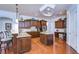 Spacious kitchen featuring an island, granite countertops, stainless steel appliances, and wood flooring at 16318 Palmettoglen Ct, Lithia, FL 33547