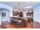Modern kitchen featuring dark cabinetry, a center island, granite countertops, and stainless appliances at 16318 Palmettoglen Ct, Lithia, FL 33547