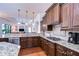 Well-equipped kitchen with stainless steel appliances, granite countertops, and wooden cabinets at 16318 Palmettoglen Ct, Lithia, FL 33547