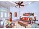Comfortable living room featuring a tray ceiling, hardwood floors, artwork and cozy furniture at 16318 Palmettoglen Ct, Lithia, FL 33547