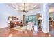 Spacious living room with high tray ceilings and hardwood floors with access to screened patio at 16318 Palmettoglen Ct, Lithia, FL 33547