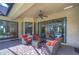 Outdoor covered patio featuring comfortable seating, brick pavers, and views of the screened-in pool at 16318 Palmettoglen Ct, Lithia, FL 33547