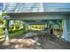 View underneath elevated home showing parking and partially enclosed space at 18716 Lake Commiston Dr, Lutz, FL 33549