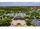 An aerial view of community center featuring pools, clubhouse, tennis courts and lush landscaping at 20118 Heron Crossing Dr, Tampa, FL 33647