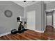 View of a bedroom featuring wood floors, and a stationary bike at 20118 Heron Crossing Dr, Tampa, FL 33647