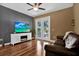 Cozy living room featuring a TV, a fireplace, and a leather couch at 20118 Heron Crossing Dr, Tampa, FL 33647