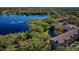 Stunning aerial view of the community with a beautiful lake, lush trees, and well-maintained buildings at 2019 Utopian W Dr # 310, Clearwater, FL 33763