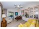 Bright living room boasts built-in shelving, a ceiling fan, and wood floors at 2019 Utopian W Dr # 310, Clearwater, FL 33763