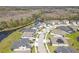 Aerial view showcases homes near a winding waterway, combining nature with modern living in a beautiful community at 21396 Snowy Orchid Ter, Land O Lakes, FL 34637