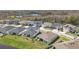 Picturesque aerial view of a neighborhood featuring ponds and well-maintained homes in a serene and tranquil setting at 21396 Snowy Orchid Ter, Land O Lakes, FL 34637