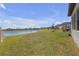 Lush backyard and lakefront view create a serene oasis, offering privacy and natural beauty at 21396 Snowy Orchid Ter, Land O Lakes, FL 34637