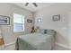 Bright bedroom with a queen bed and a sunny window view at 21396 Snowy Orchid Ter, Land O Lakes, FL 34637