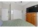 Cozy bedroom featuring a queen bed, closet, and neutral decor at 21396 Snowy Orchid Ter, Land O Lakes, FL 34637