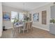 Bright dining area with a chandelier, large window, and stylish decor and view to the yard at 21396 Snowy Orchid Ter, Land O Lakes, FL 34637