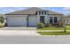 Beautiful one-story home with a two-car garage and a well-manicured lawn at 21396 Snowy Orchid Ter, Land O Lakes, FL 34637