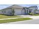 Charming home with a three-car garage, well-manicured lawn, and neatly landscaped flowerbeds enhancing curb appeal at 21396 Snowy Orchid Ter, Land O Lakes, FL 34637