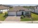Beautiful one-story home with a two-car garage, manicured lawn, and pond view at 21396 Snowy Orchid Ter, Land O Lakes, FL 34637
