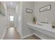 The hallway features a light wood floor, neutral paint, and a built-in desk area at 21396 Snowy Orchid Ter, Land O Lakes, FL 34637