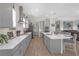 Modern kitchen features gray cabinets, white countertops, stainless steel appliances, and a functional island with seating at 21396 Snowy Orchid Ter, Land O Lakes, FL 34637